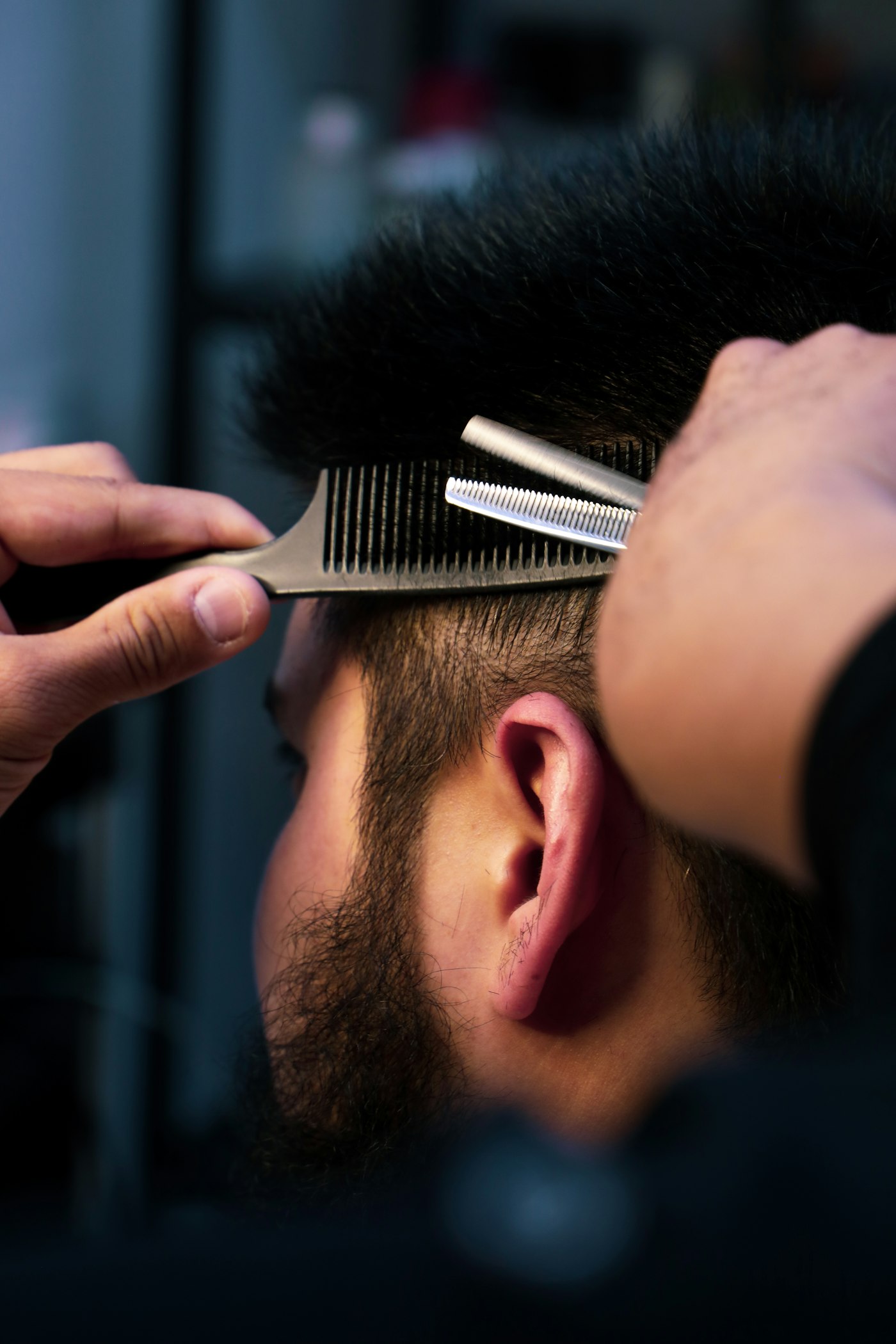 Detailed close-up of a comb running through a fresh fade